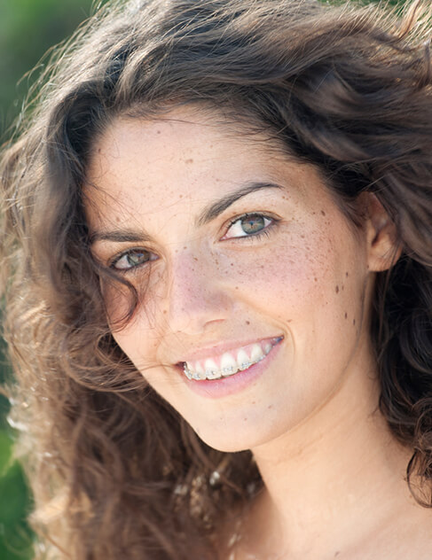 young, smiling woman with braces