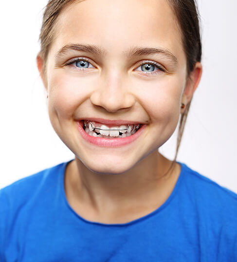 smiling young girl wearing an orthodontic appliance