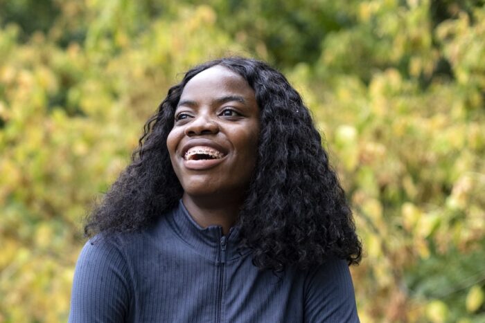 smiling Black woman in braces, orthodontics and overall health