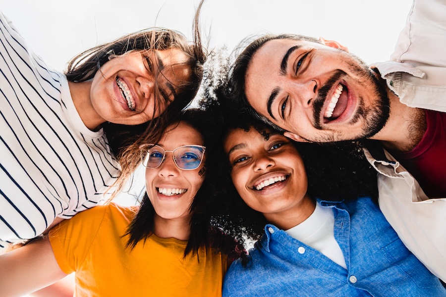 group of friends smiling and one has braces in 2026