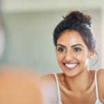 woman with straight teeth and straight smile thinking of benefits of straight teeth